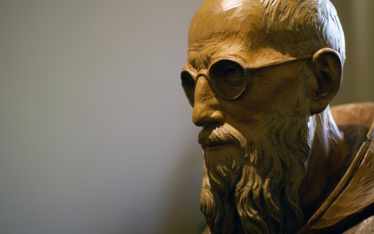 A close-up photo of a wood handcarved statue of Blessed Solanus Casey located in St. Bonaventure Chapel