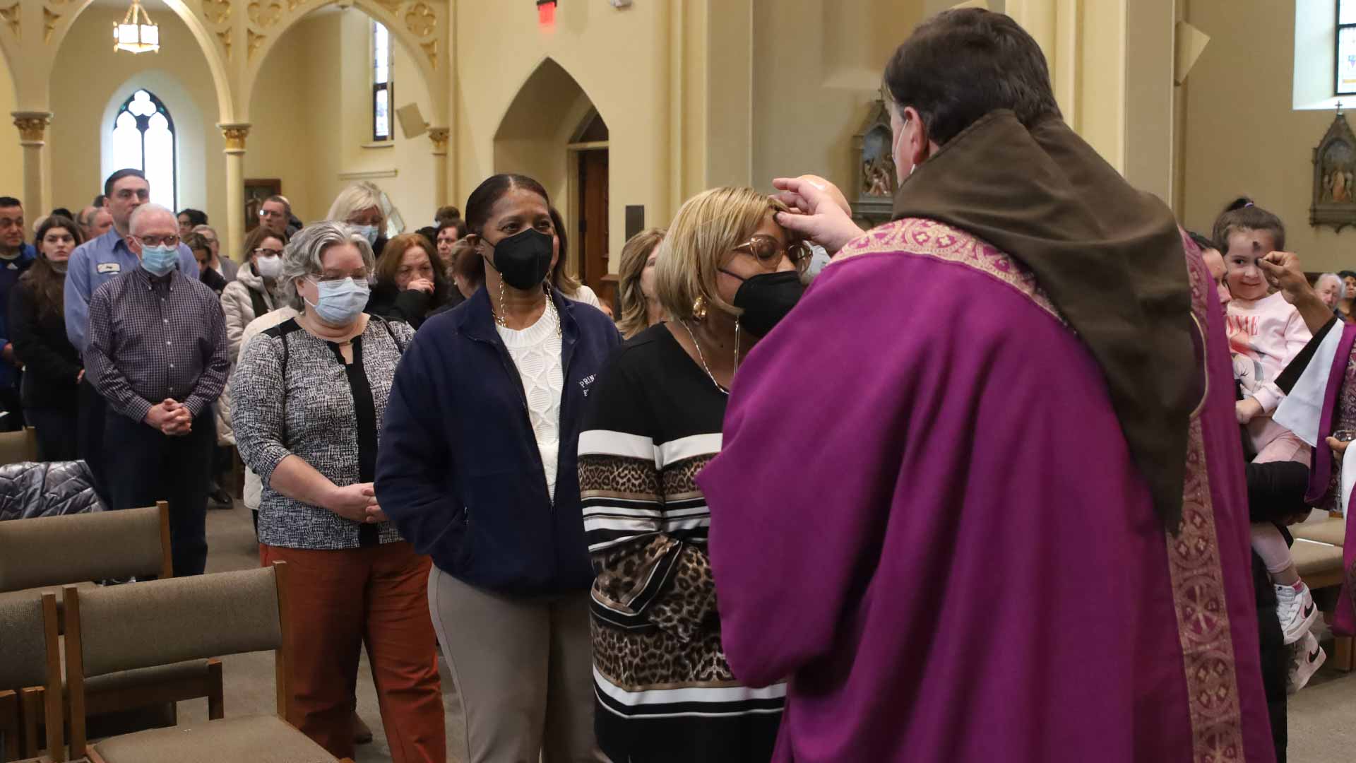 Capuchin Father Steve Kropp places ashes on the forehead of a Massgoer on Ash Wednesday, March 2, 2022 in the sanctuary of St. Bonaventure Chapel in Detroit, Michigan.