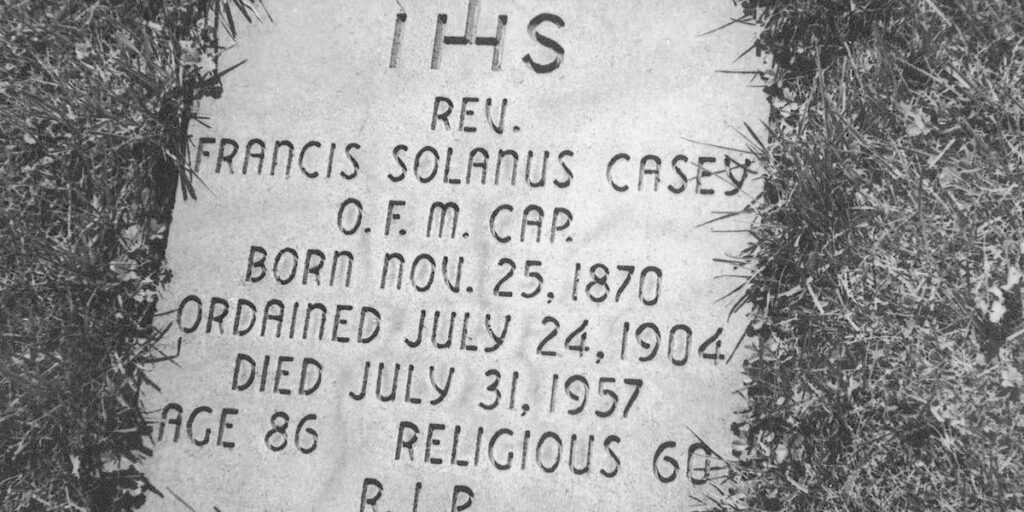 A black-and-white close up photograph of the grave marker formerly in the back yard of St. Bonaventure Monastery where Blessed Solanus was initially interred before being moved to the transept of St. Bonaventure Chapel (now part of the Solanus Casey Center).