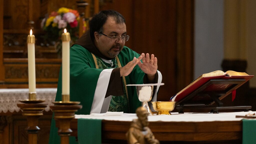 Friar Vito Martinez, OFM Cap. prays the Eucharistic prayer during Mass.