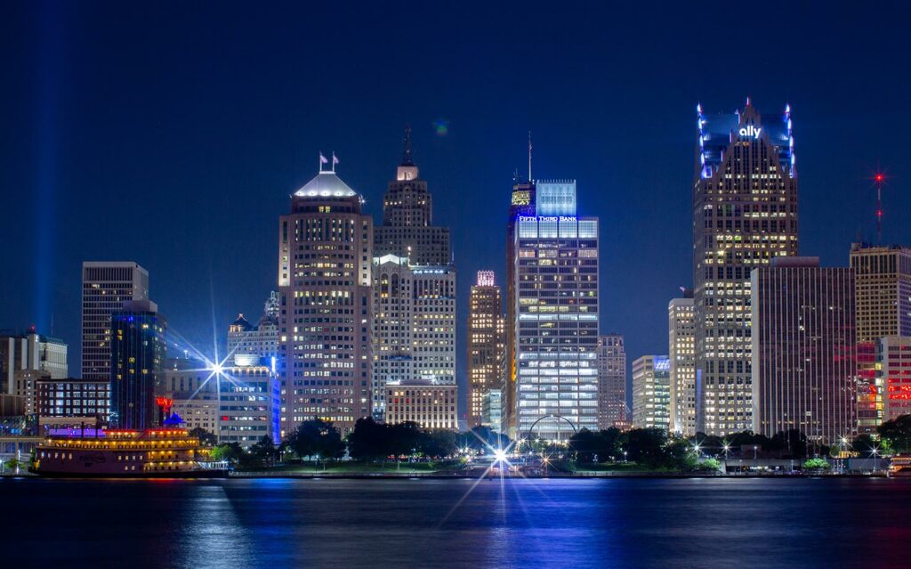 Color photograph of the downtown Detroit skyline at night shot from acrross the Detroit River in Windsor, Ontario.