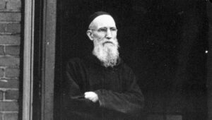 Solanus Casey standing in the doorway of the monastery.